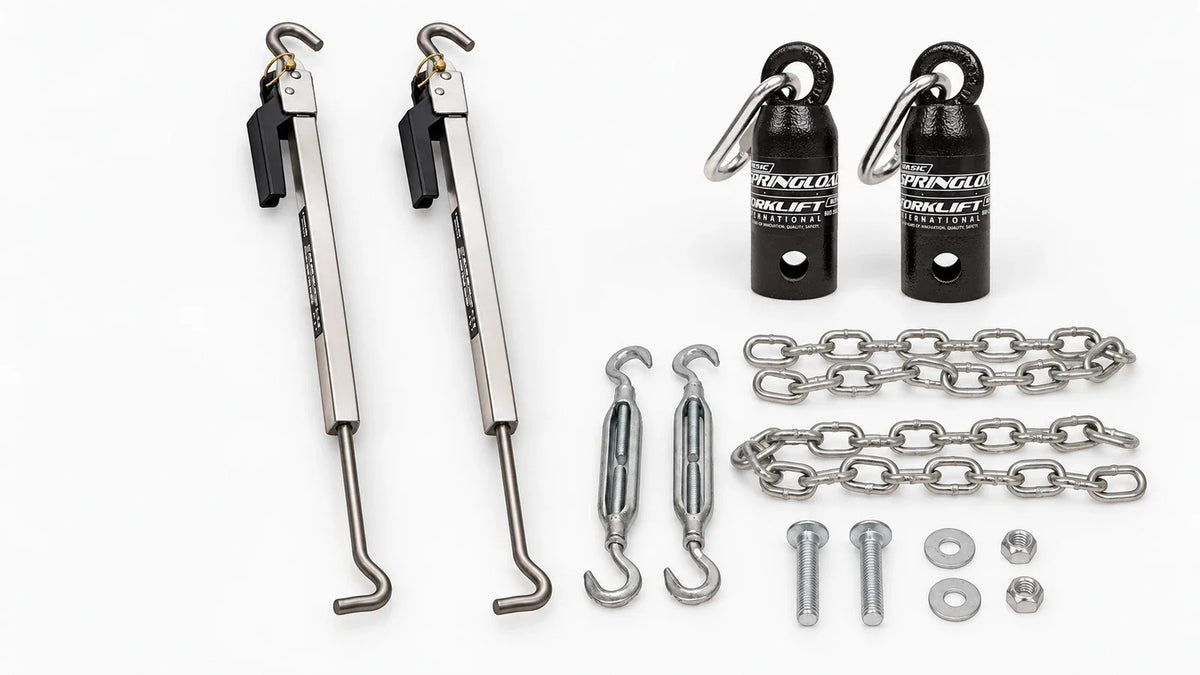 Two polished TorkLift Original FastGun turnbuckles beside the Basic SpringLoad kit with two black canisters, forged turnbuckles, chains and mounting hardware on a light background.