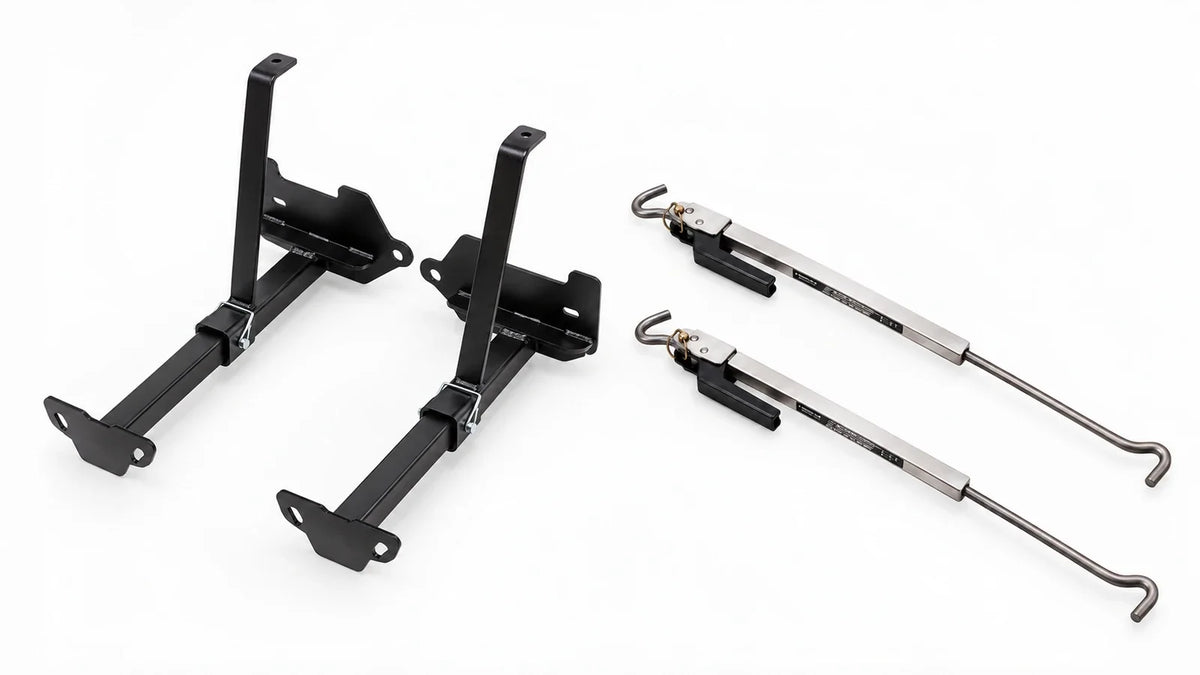 A black TorkLift C2225 front camper tie-down pair on the left beside two polished S9526 Original FastGun turnbuckles on a light background.