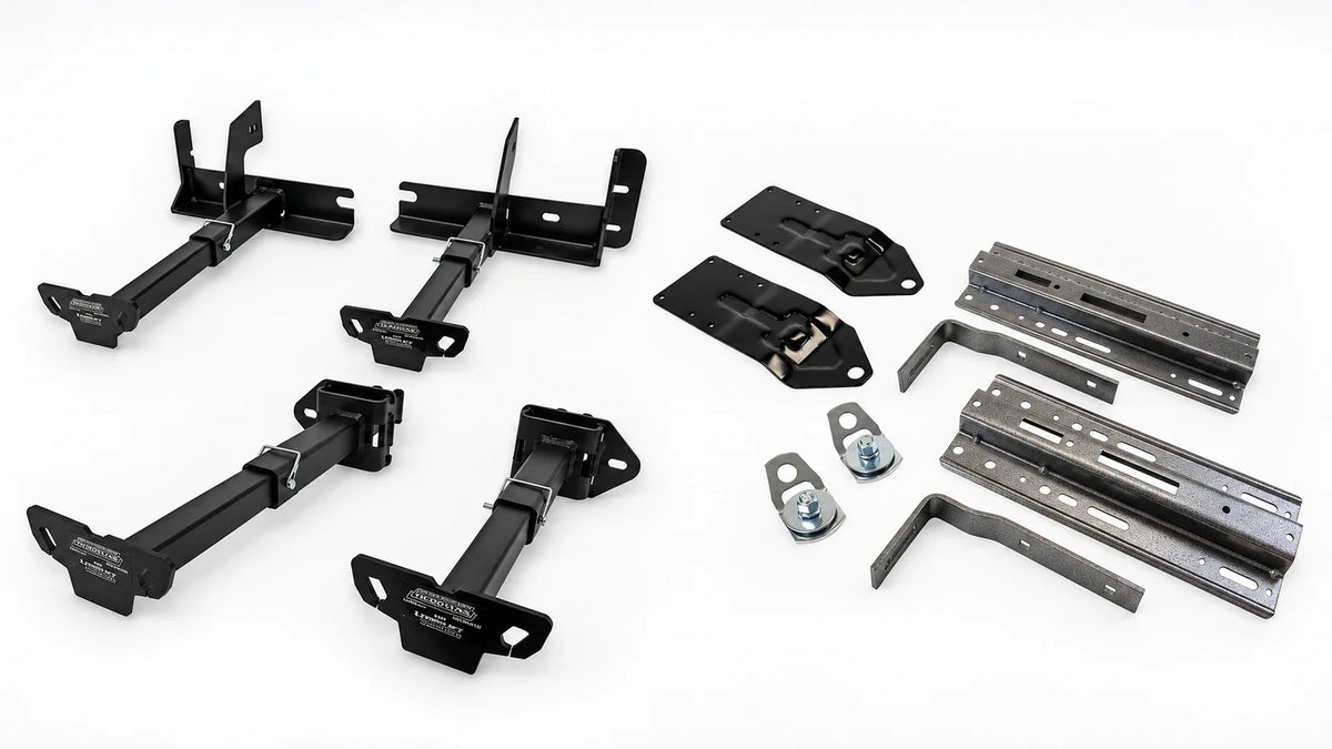 Examples of TorkLift F2031 and F3008 camper tie-down brackets on the left and HappiJac FT-CG9 tie-down components on the right, on a light background.